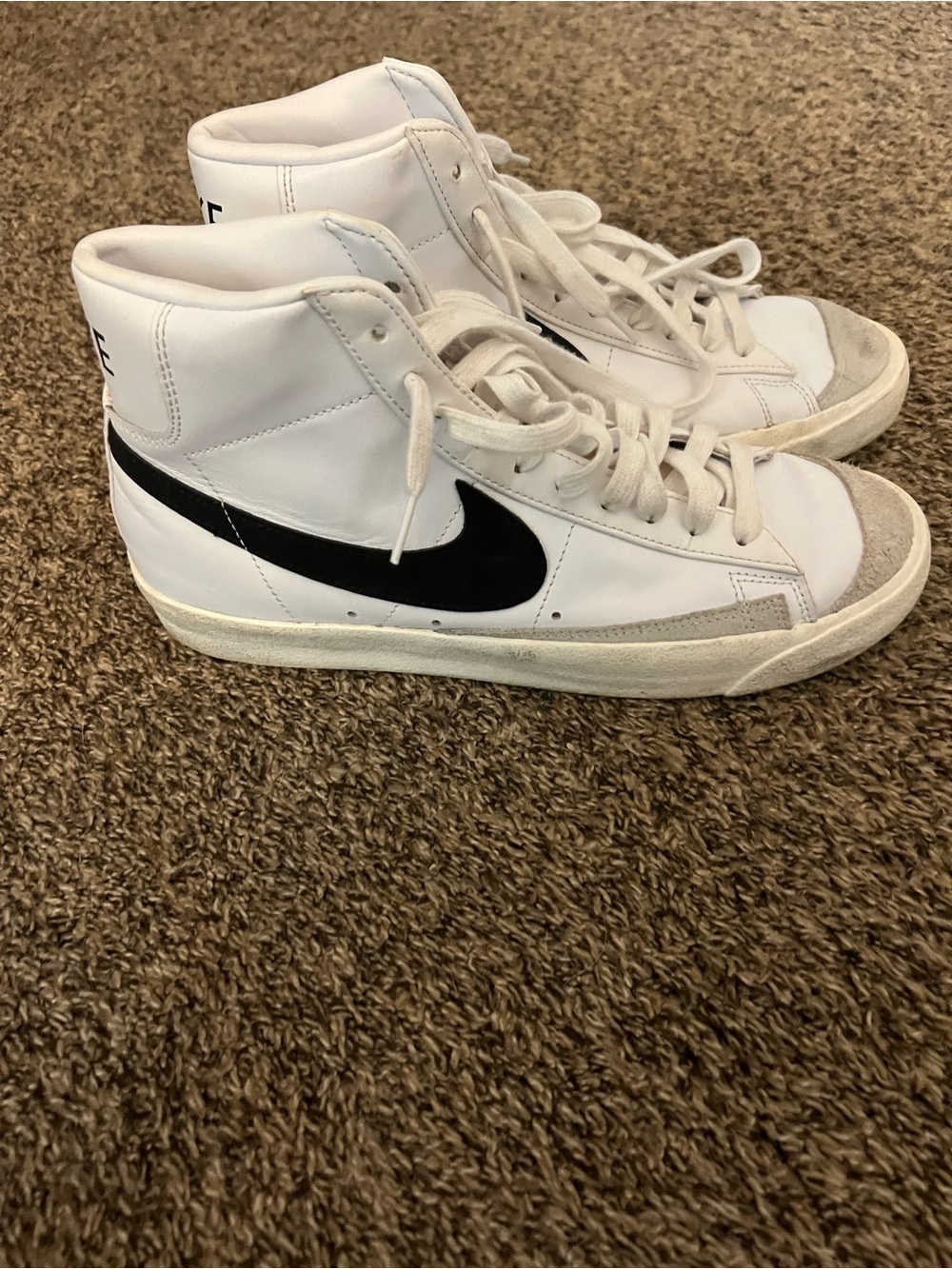 Nike White High-Top Sneakers with Black Swoosh